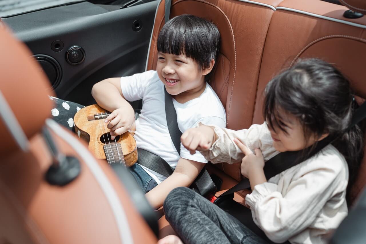 children riding in car